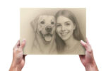 A pencil sketch prting of a girl and dog